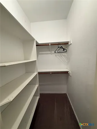 a large kitchen with stainless steel appliances a stove a sink and a refrigerator