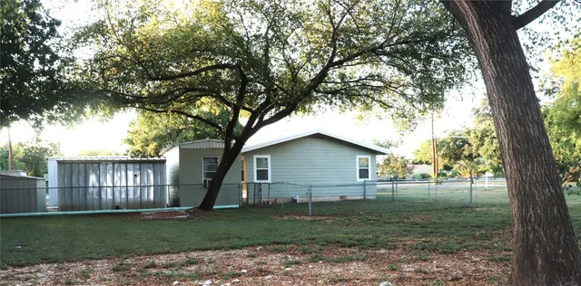 a view of a wooden house with a yard
