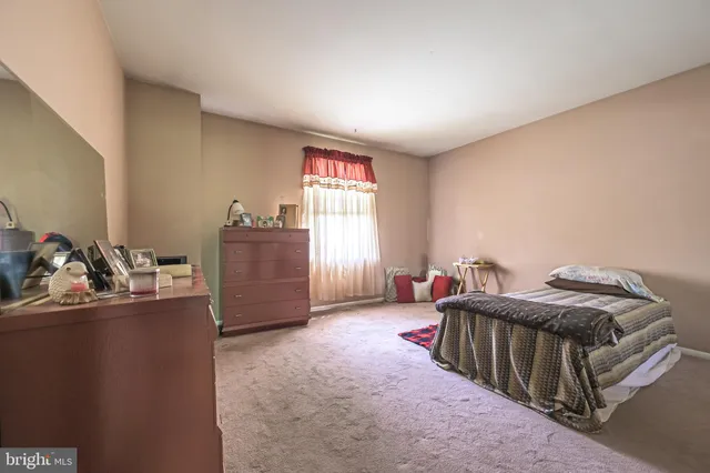 a bathroom with a granite countertop sink mirror vanity and toilet