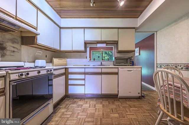 a kitchen with a white stove top oven and refrigerator
