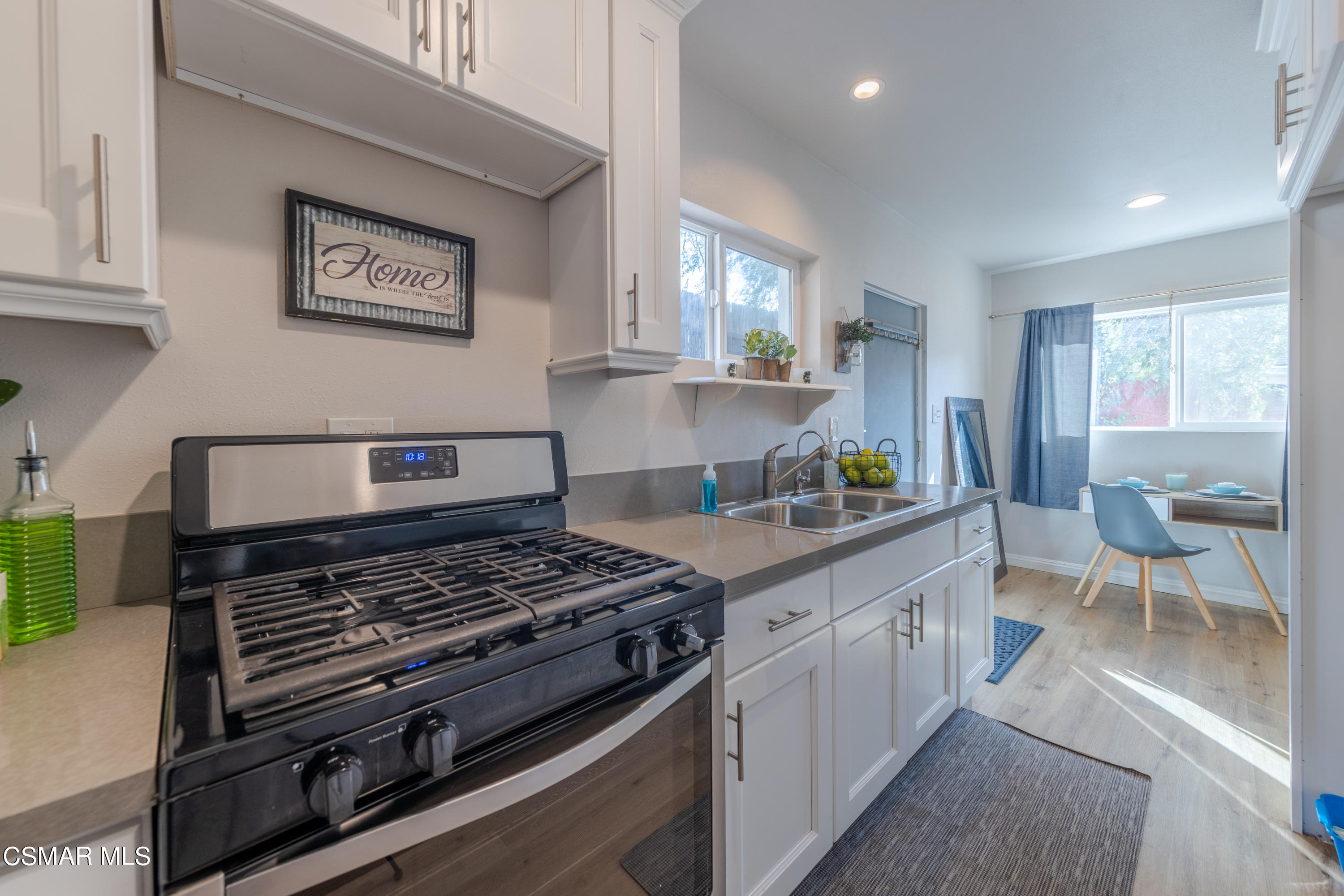 5935 Oak Knolls Road Simi Valley, CA 93063 - Photo 8 of 24 a kitchen with stainless steel appliances granite countertop a stove a sink and a refrigerator
