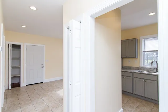 a view of a kitchen cabinets a sink and dishwasher a refrigerator with wooden floor