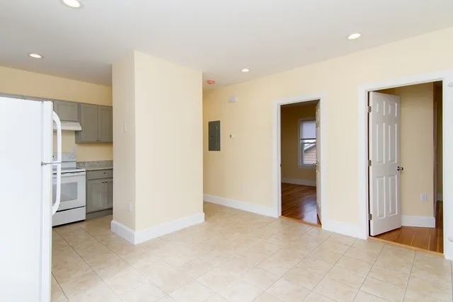 a view of a kitchen with refrigerator and an oven
