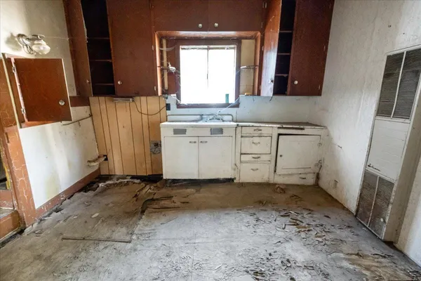a room with granite countertop a sink a washer and dryer