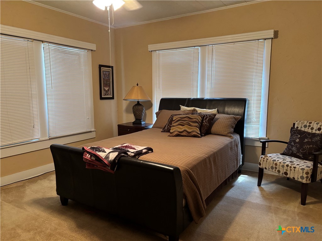 613 East Broadway Street, Unit 5 Cuero, TX 77954 - Photo 15 of 34 a bedroom with bed and window