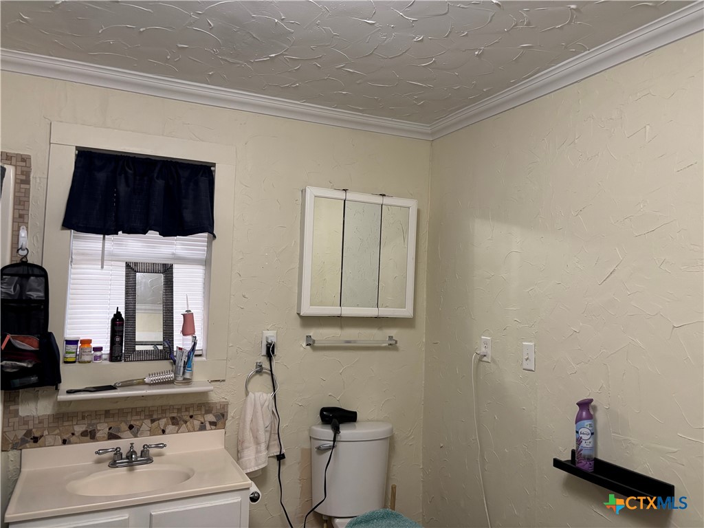 613 East Broadway Street, Unit 5 Cuero, TX 77954 - Photo 16 of 34 a bathroom with a sink and a mirror
