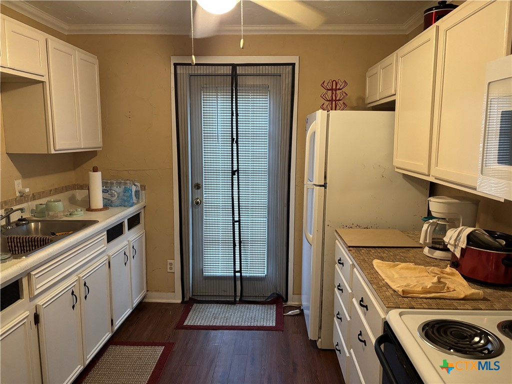 613 East Broadway Street, Unit 5 Cuero, TX 77954 - Photo 19 of 34 a kitchen with a sink a stove and cabinets