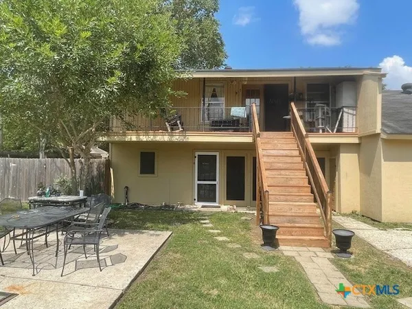 a view of a backyard with wooden fence
