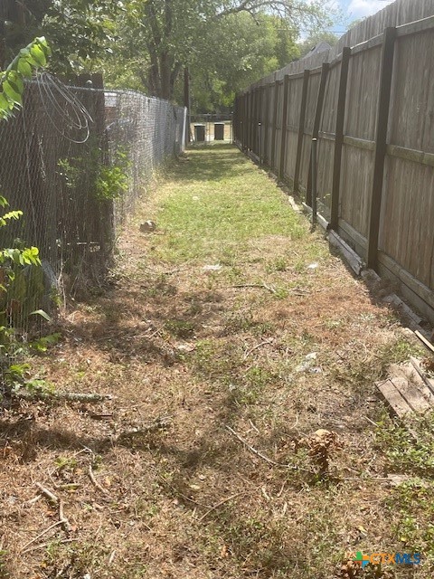 613 East Broadway Street, Unit 5 Cuero, TX 77954 - Photo 24 of 34 a view of a backyard with wooden fence