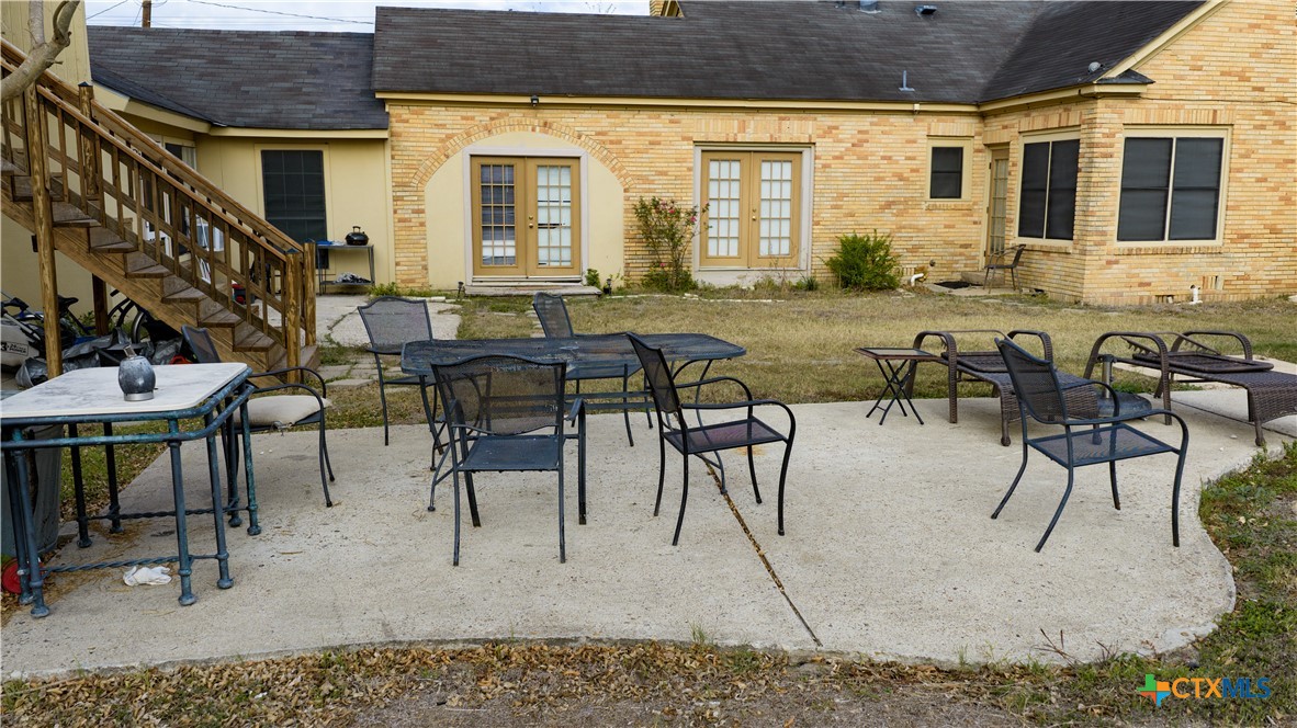 613 East Broadway Street, Unit 5 Cuero, TX 77954 - Photo 26 of 34 a view of a patio with table and chairs