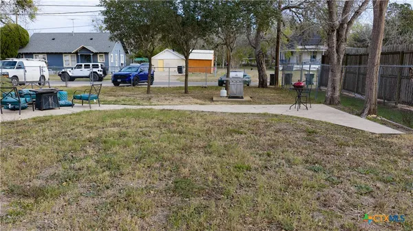 a view of house with backyard and sitting area