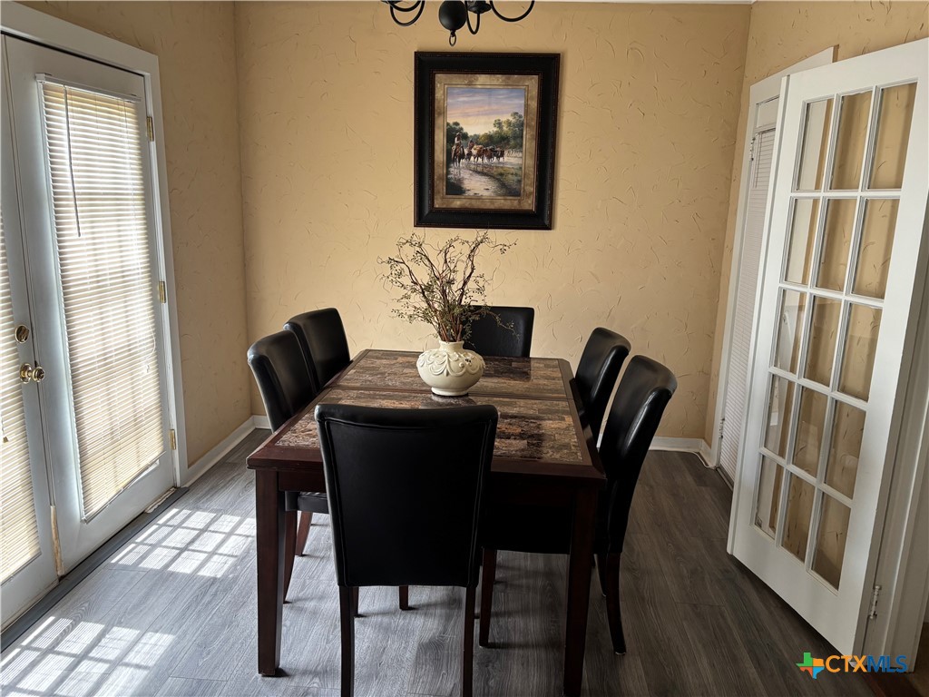 613 East Broadway Street, Unit 5 Cuero, TX 77954 - Photo 10 of 34 a view of a dining room with furniture window and wooden floor