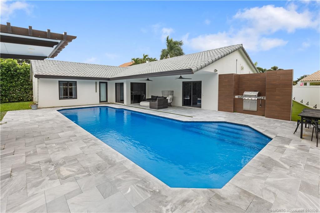 5143 Deerhurst Crescent Circle Boca Raton, FL 33486 - Photo 1 of 47 a view of backyard with swimming pool and seating space