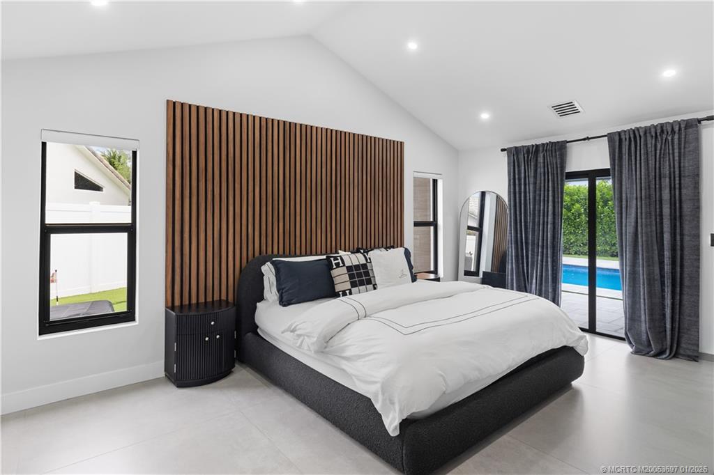 5143 Deerhurst Crescent Circle Boca Raton, FL 33486 - Photo 11 of 47 a bedroom with a large bed and a window