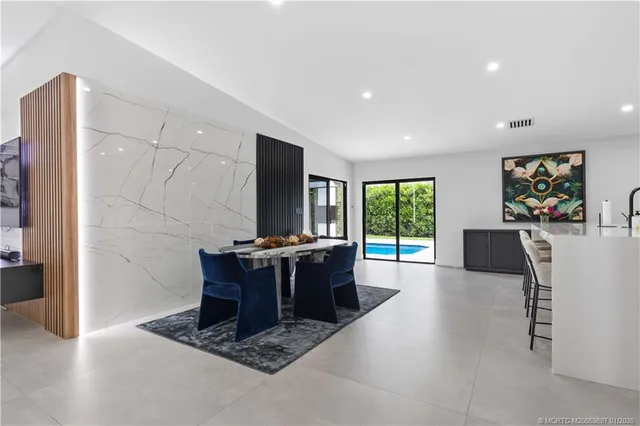 a living room with furniture a large window and a flat screen tv