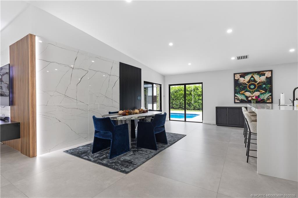 5143 Deerhurst Crescent Circle Boca Raton, FL 33486 - Photo 14 of 47 a living room with furniture a large window and a flat screen tv