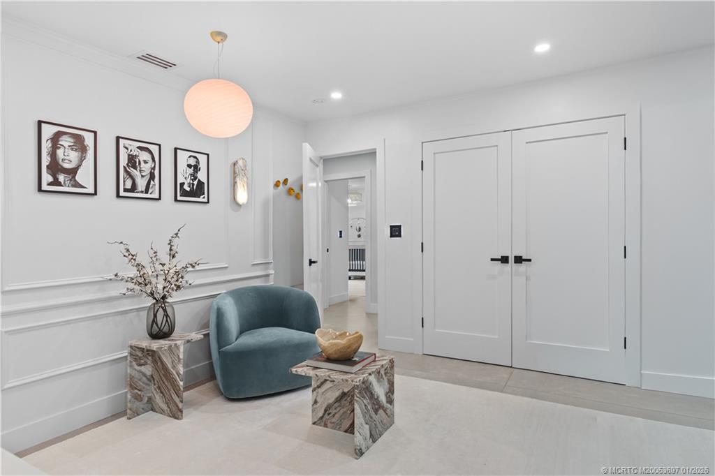 5143 Deerhurst Crescent Circle Boca Raton, FL 33486 - Photo 19 of 47 a living room with furniture and a chandelier