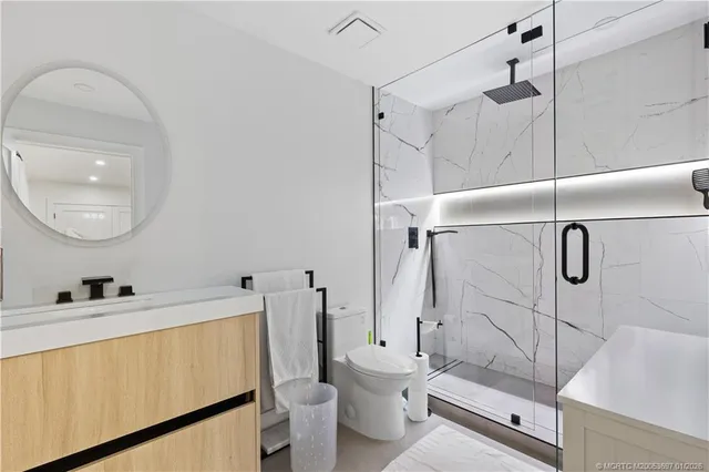 a bathroom with a sink toilet and shower