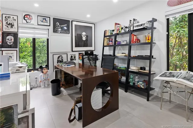 a dining room with furniture and a floor to ceiling window