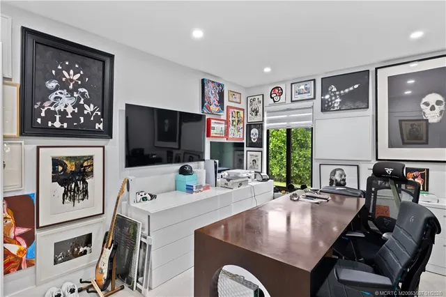 a living room with furniture a flat screen tv and a large window
