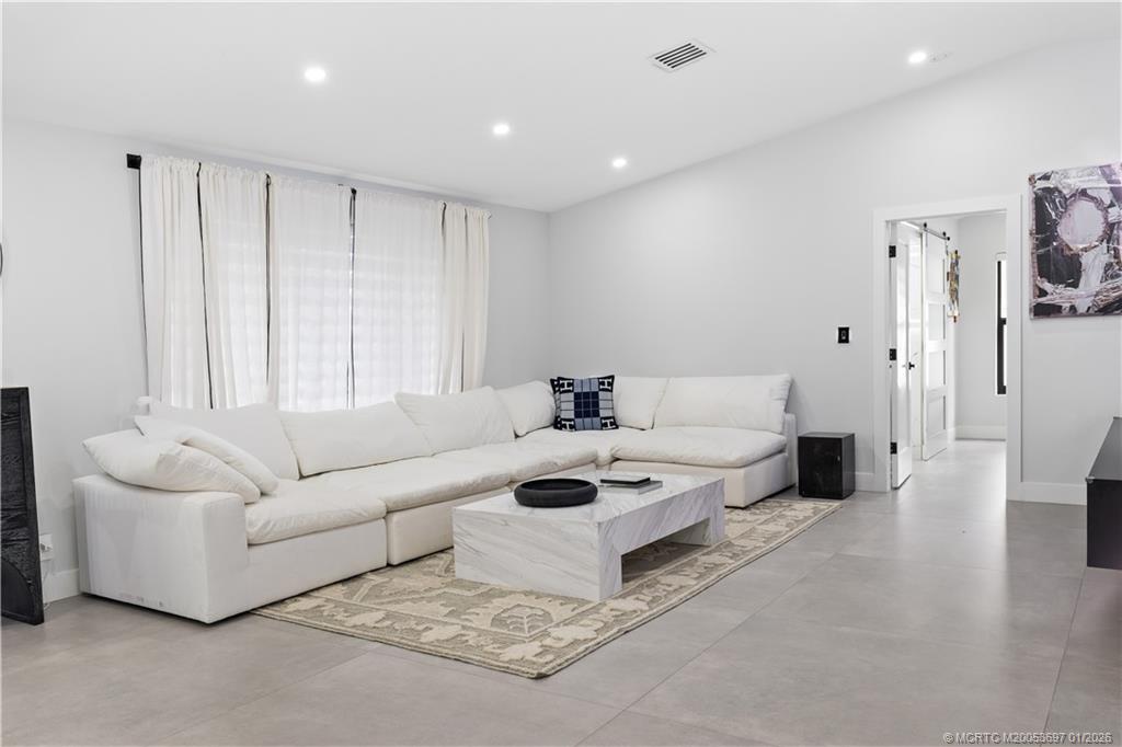 5143 Deerhurst Crescent Circle Boca Raton, FL 33486 - Photo 29 of 47 a living room with furniture and a large window