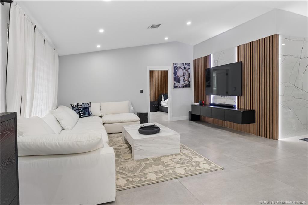 5143 Deerhurst Crescent Circle Boca Raton, FL 33486 - Photo 30 of 47 a living room with furniture and a flat screen tv