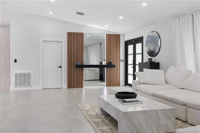 a living room with furniture and a mirror