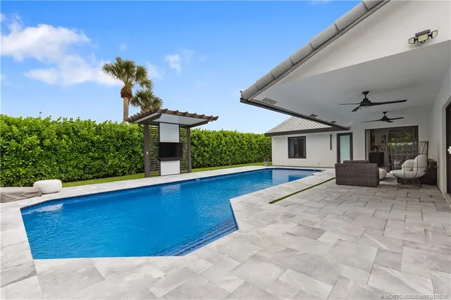 a view of a house with backyard and sitting area