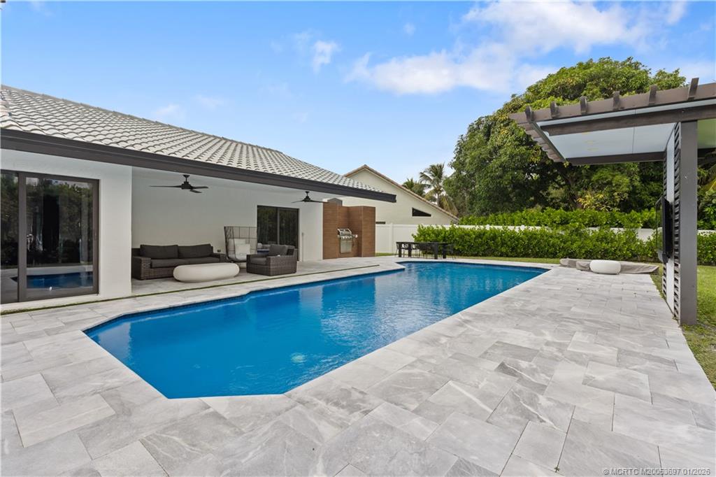 5143 Deerhurst Crescent Circle Boca Raton, FL 33486 - Photo 39 of 47 a view of a house with swimming pool and a porch