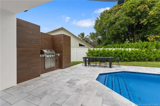 a view of a backyard with sitting area