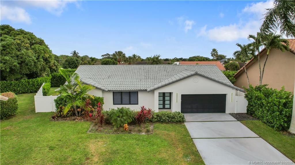 5143 Deerhurst Crescent Circle Boca Raton, FL 33486 - Photo 46 of 47 a front view of a house with a garden