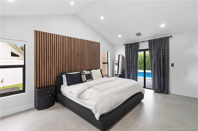 a bedroom with a large bed and a large window