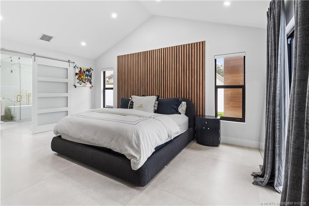 5143 Deerhurst Crescent Circle Boca Raton, FL 33486 - Photo 6 of 47 a spacious bedroom with a bed and a cabinets