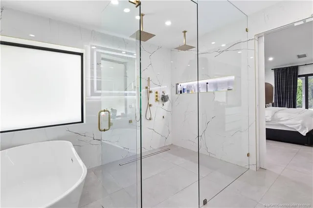 a bathroom with a bathtub and a shower