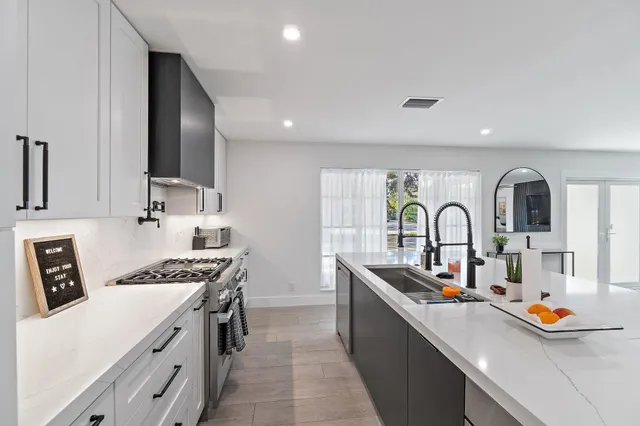 a kitchen that has a lot of cabinets in it