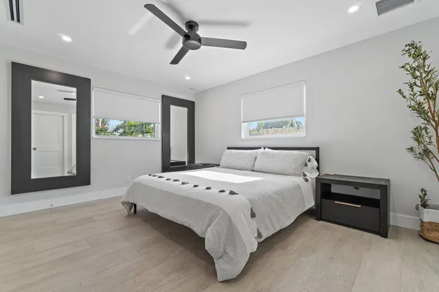 a spacious bedroom with a bed and a chandelier