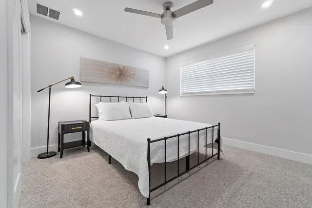 a bed room with a bed and a chandelier