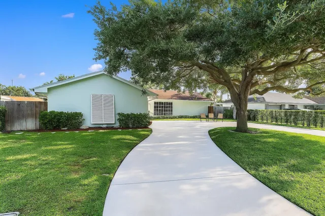 a front view of a house with yard and green space