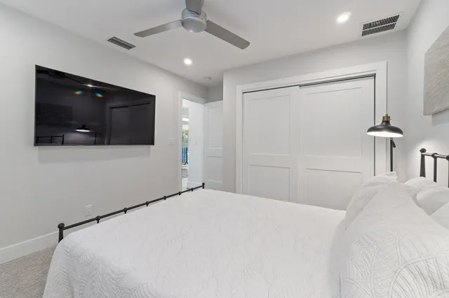 a bedroom with a bed and a flat screen tv