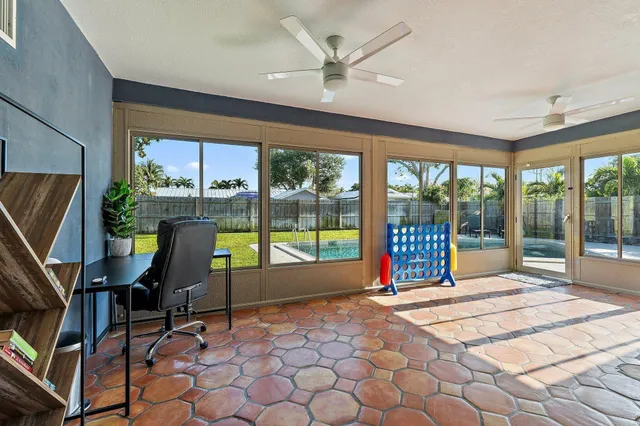 a living room filled with furniture and a floor to ceiling window