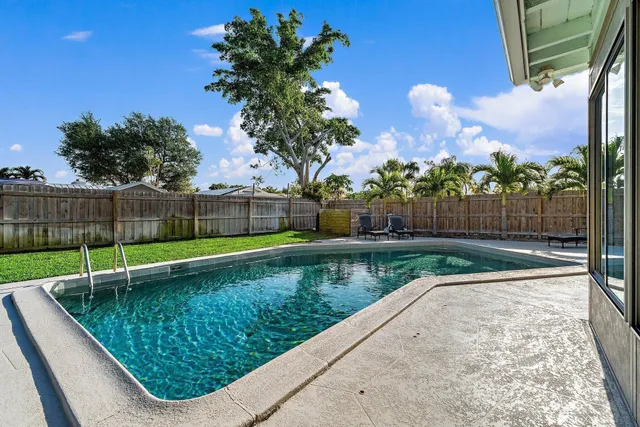 a view of a garden with wooden fence