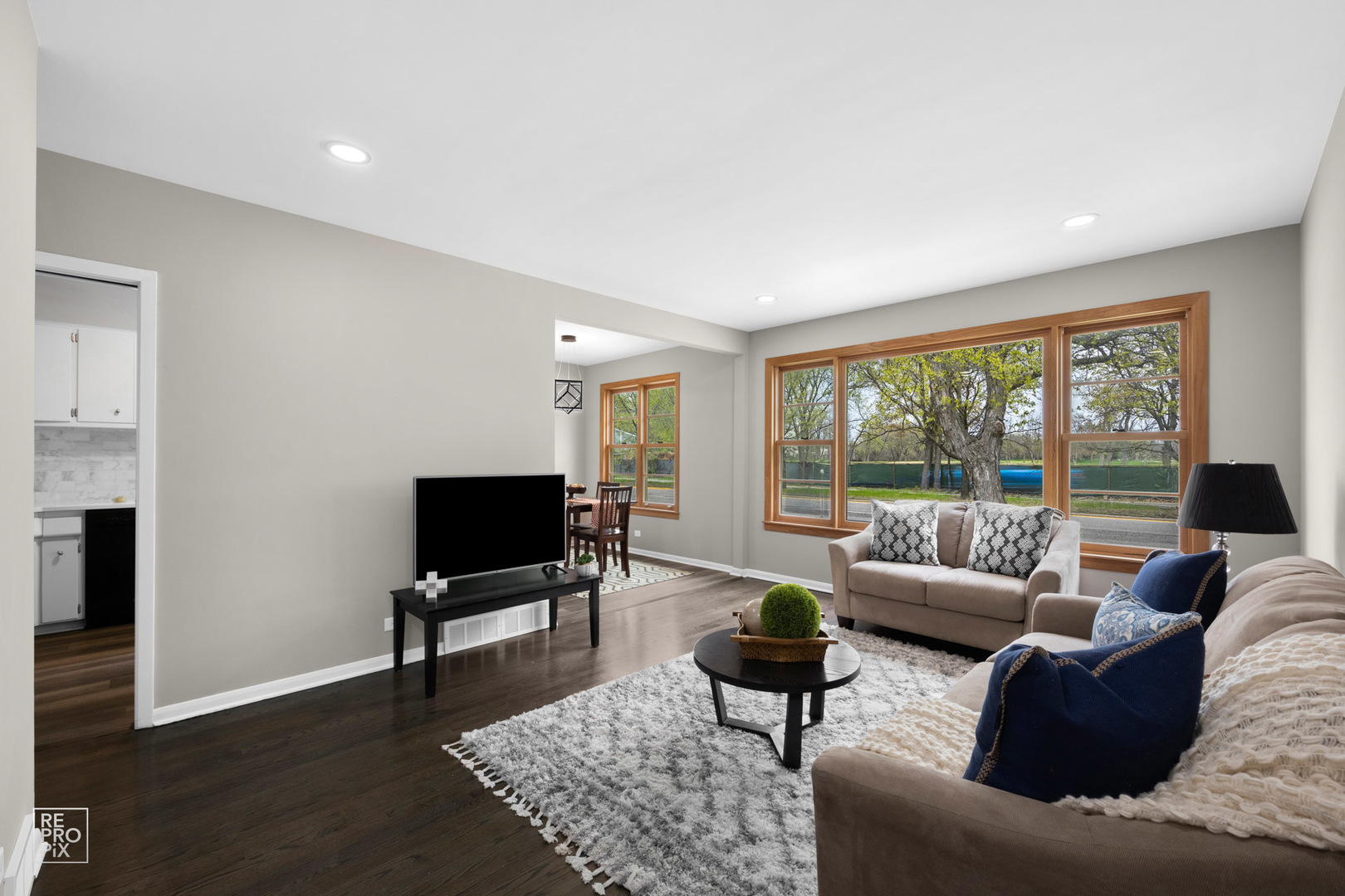 4319 West Devon Avenue Chicago, IL 60646 - Photo 2 of 10 a living room with furniture and a flat screen tv