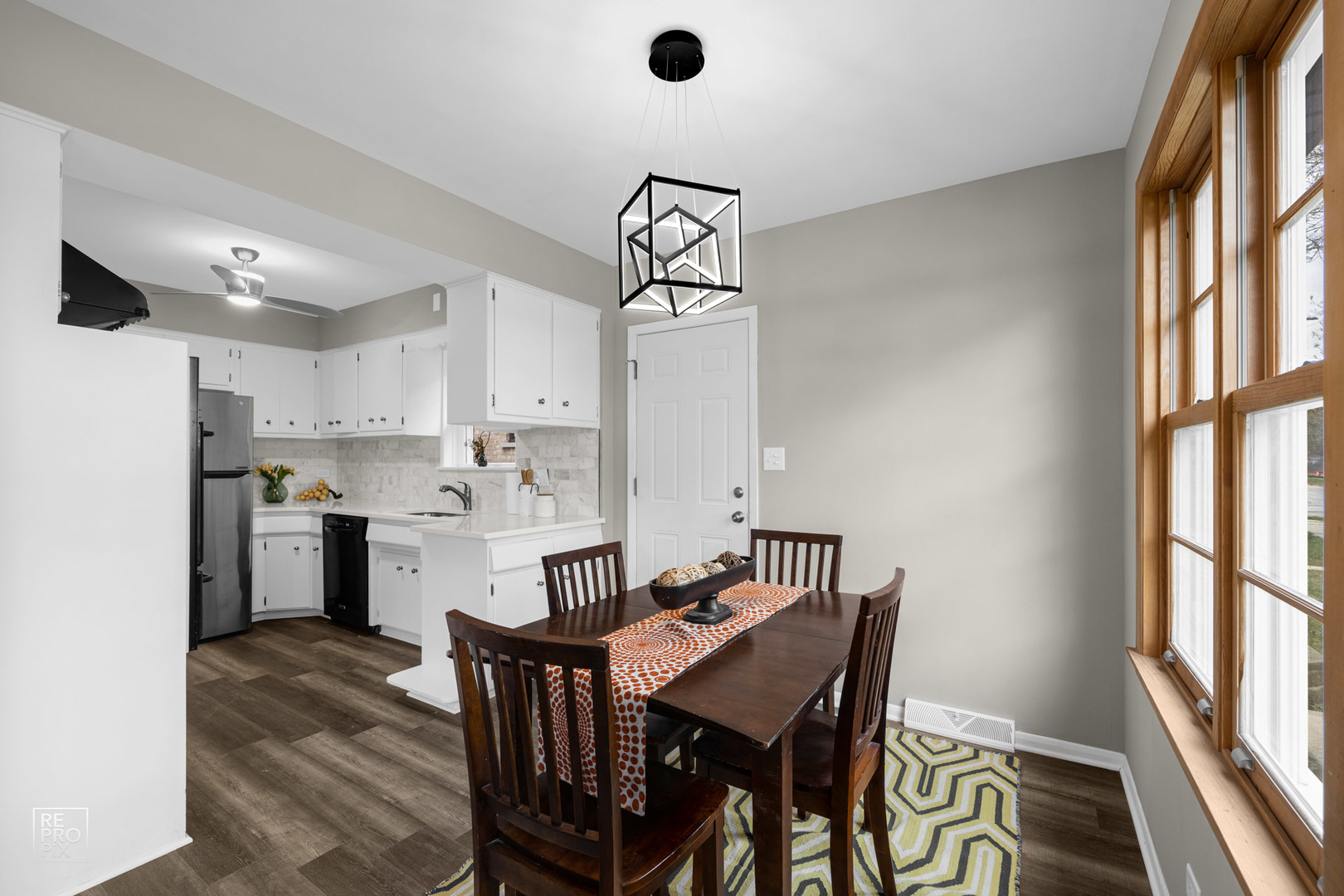 4319 West Devon Avenue Chicago, IL 60646 - Photo 3 of 10 a kitchen with a table chairs refrigerator and microwave