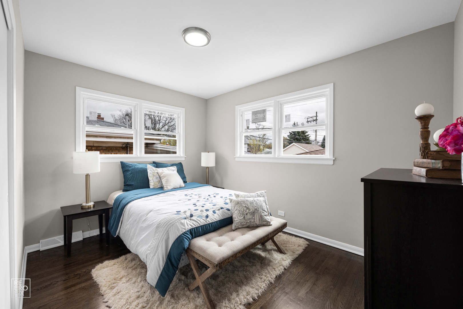 4319 West Devon Avenue Chicago, IL 60646 - Photo 5 of 10 a bedroom with a bed and wooden floor