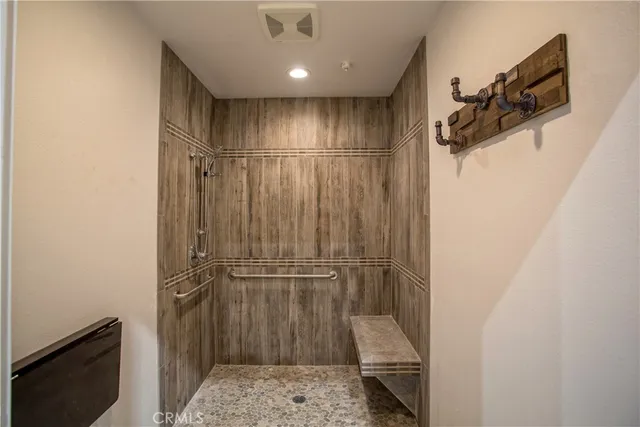 a kitchen with stainless steel appliances a sink a stove a refrigerator and cabinets