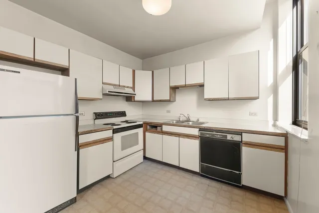 a kitchen with cabinets stainless steel appliances and a sink