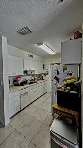a kitchen with a stove and a refrigerator