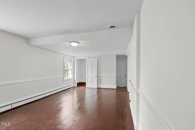 wooden floor in an empty room with a window