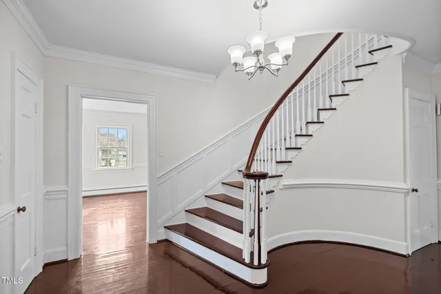 a view of entryway and hall with wooden floor