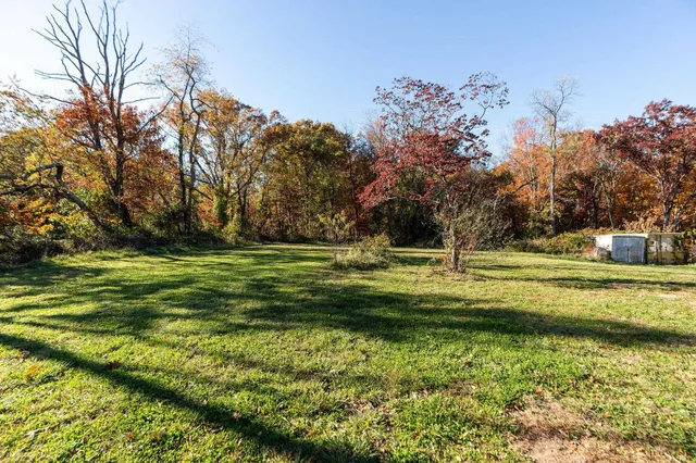 a backyard of a house with yard table and chairs